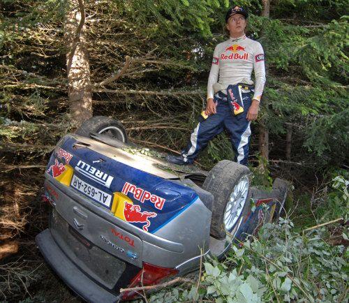 Kimi Raikkonen with his rally car overturned.