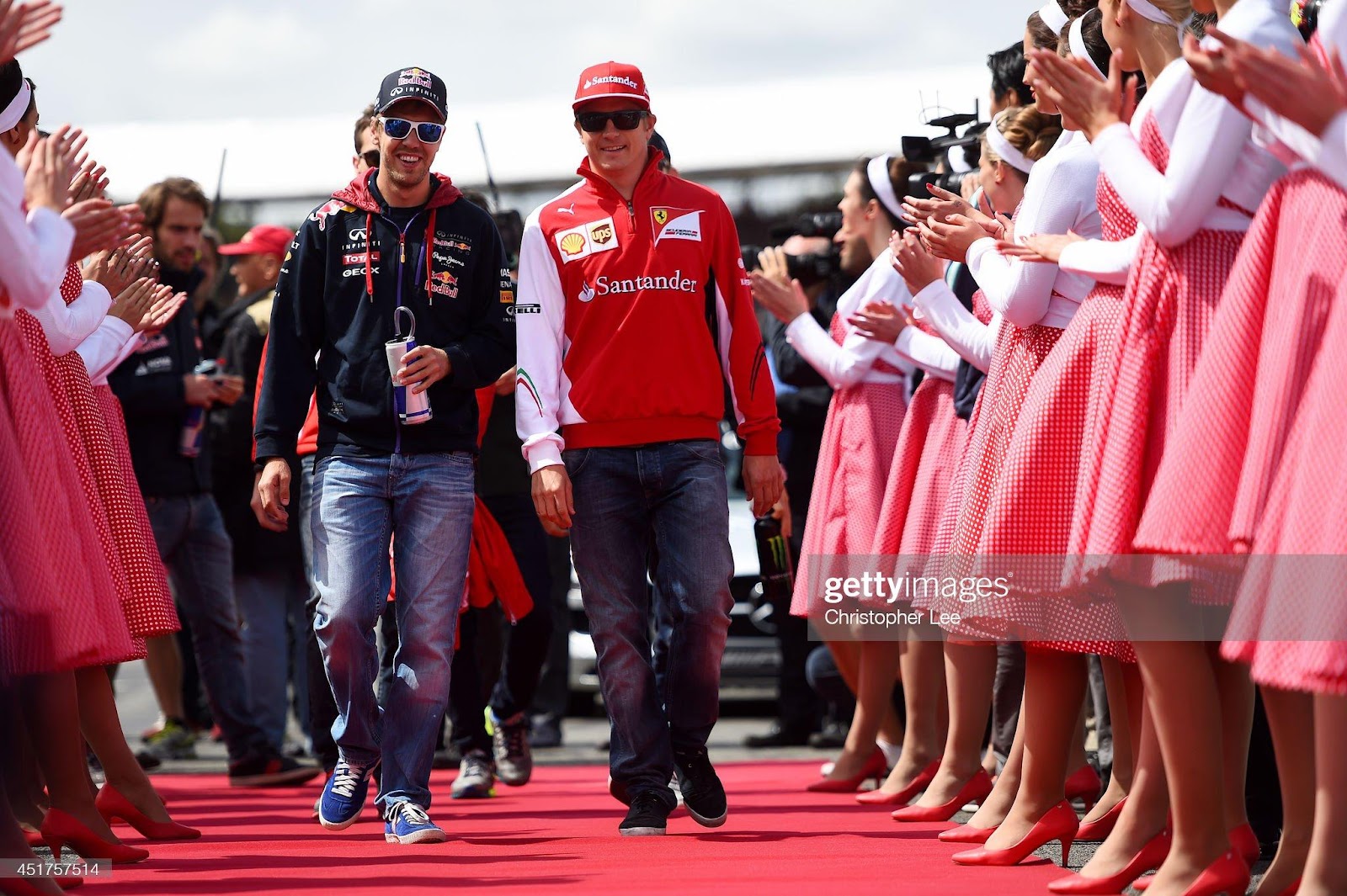 Sebastian Vettel, Red Bull Racing and Kimi Raikkonen, Ferrari, walk out for the drivers' parade during the British Formula One Grand Prix at Silverstone Circuit on July 6, 2014 in Northampton, United Kingdom.