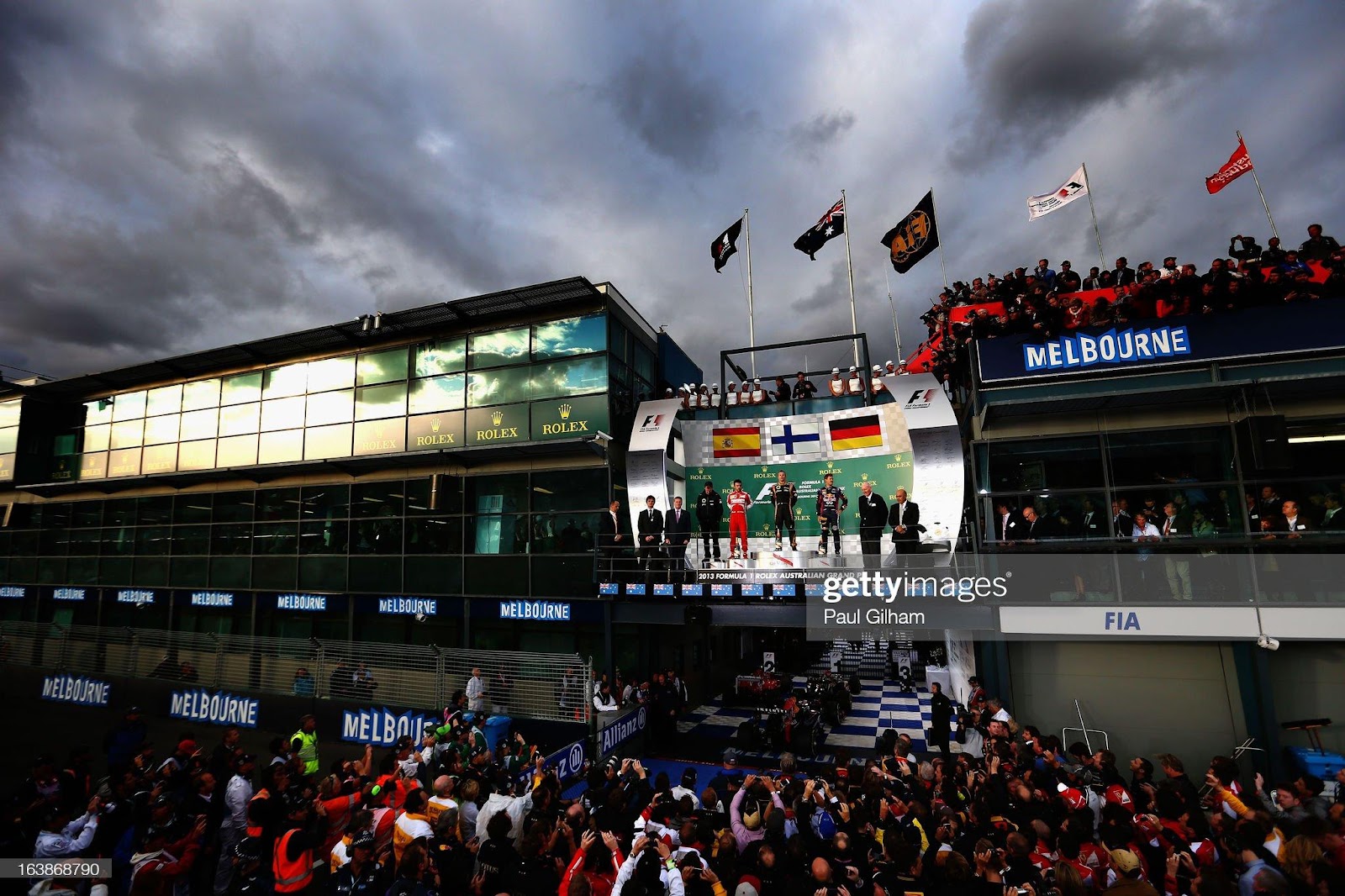 Race winner Kimi Raikkonen, Lotus, celebrates on the podium with second placed Fernando Alonso, Ferrari and third placed Sebastian Vettel, Red Bull Racing, following the Australian F1 Grand Prix at the Albert Park Circuit on March 17, 2013 in Melbourne, Australia.
