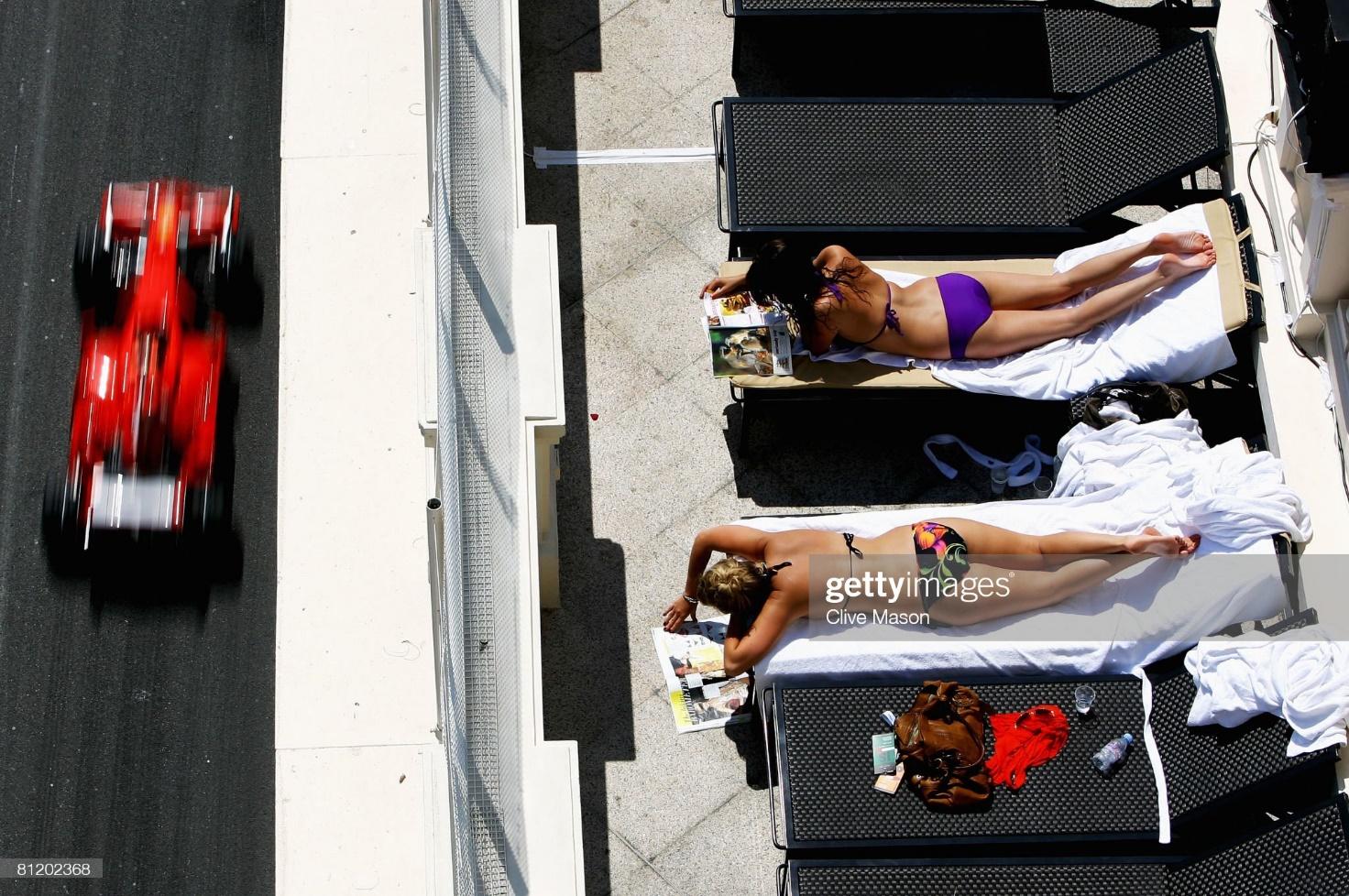 Sunbathers relax as Kimi Raikkonen drives by during practice for the Monaco F1 Grand Prix at the Monte Carlo Circuit on May 22, 2008.