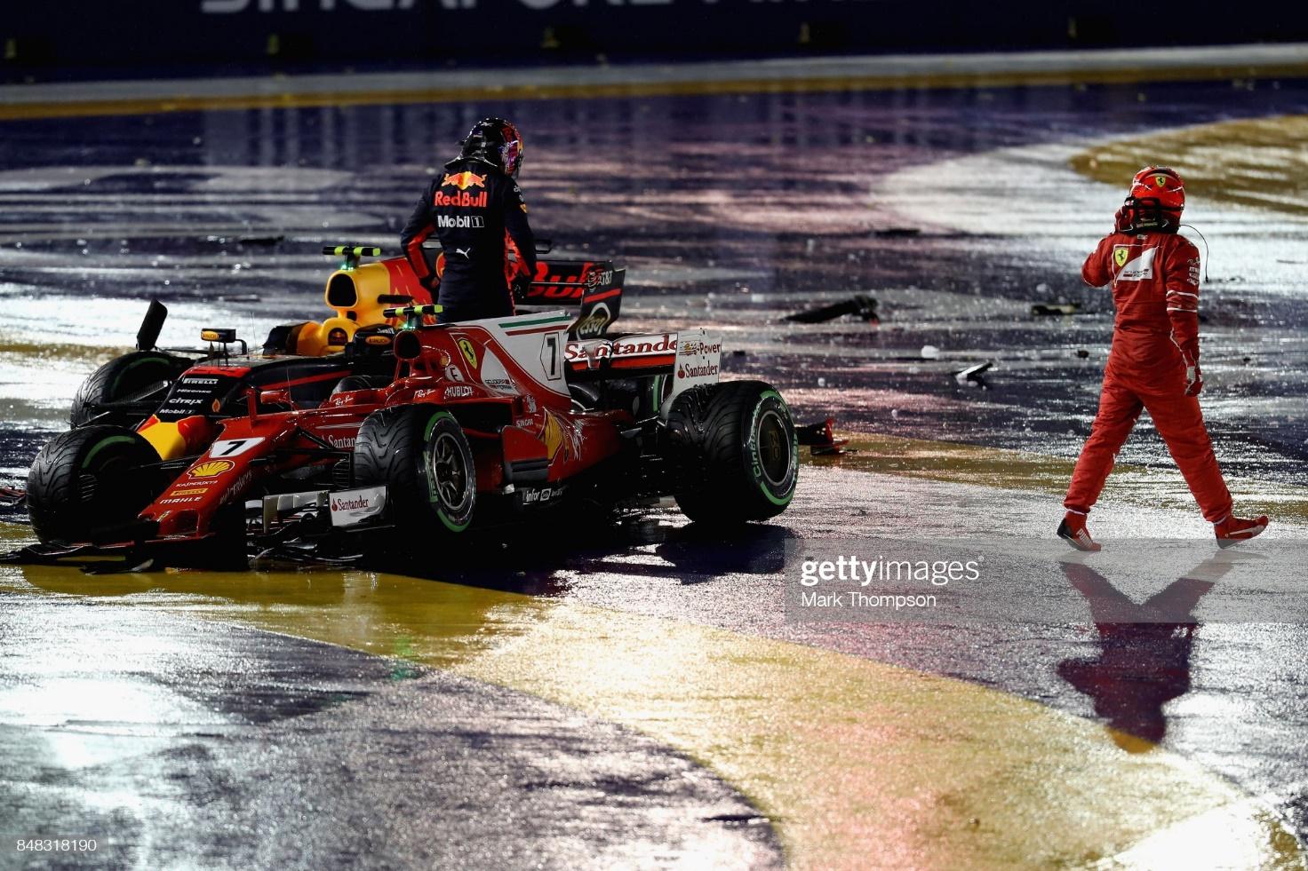 Kimi Raikkonen driving the (7) Scuderia Ferrari SF70H and Max Verstappen driving the (33) Red Bull RB13 stop at the side of the circuit after colliding at the start during the F1 Grand Prix of Singapore at Marina Bay Street Circuit on September 17, 2017.