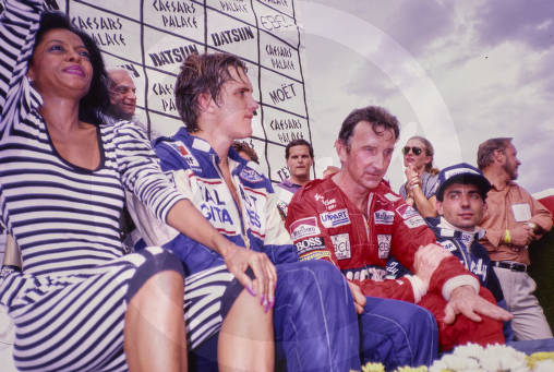 Diana Ross sits with Eddie Cheever, John Watson and Michele Alboreto in the Winner's Circle on 25 September 1982. 