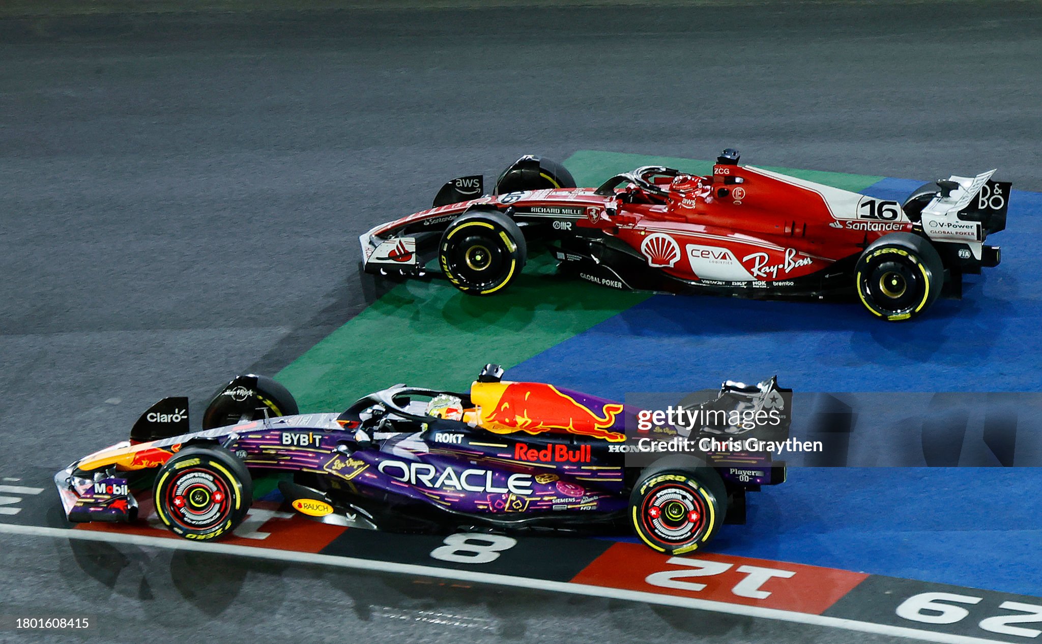 Max Verstappen of the Netherlands, driving the (1) Red Bull Racing RB19, leads Charles Leclerc of Monaco, driving the (16) Ferrari SF-23, at turn one during the F1 Grand Prix of Las Vegas at Las Vegas Strip Circuit on November 18, 2023. 