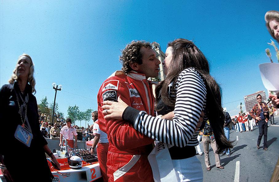 Jochen Mass kisses a promotion girl on the grid, US GP 1977.