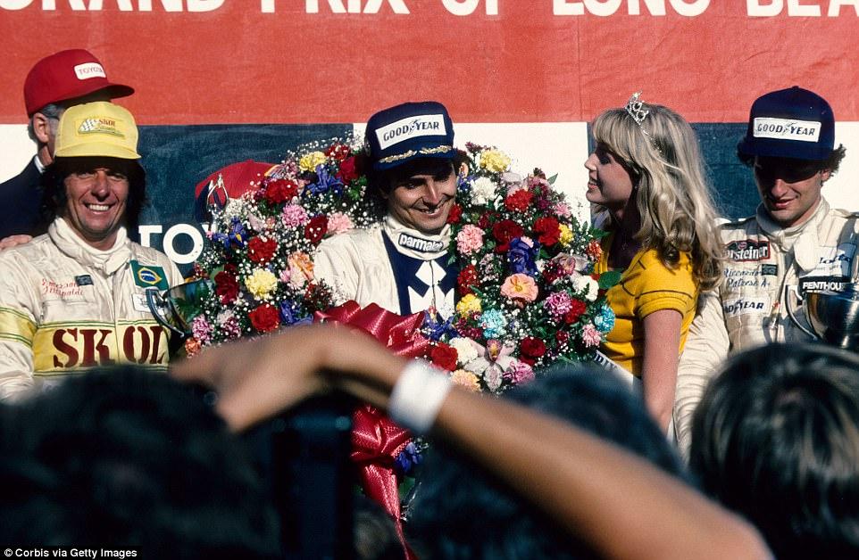 Nelson Piquet on the podium with a girl.