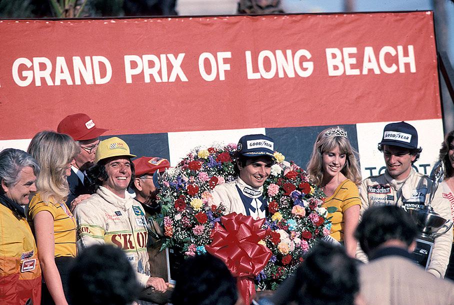 Podium ceremony after the 1980 US GP (West) in Long Beach. Third placed Emerson Fittipaldi, race winner Nelson Piquet and second placed Riccardo Patrese.