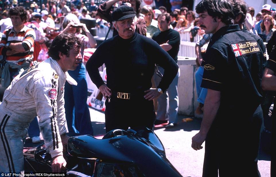 Andretti (left) would only finish second a year later as the American engages in discussion with his Lotus team including boss Colin Chapman (centre). 