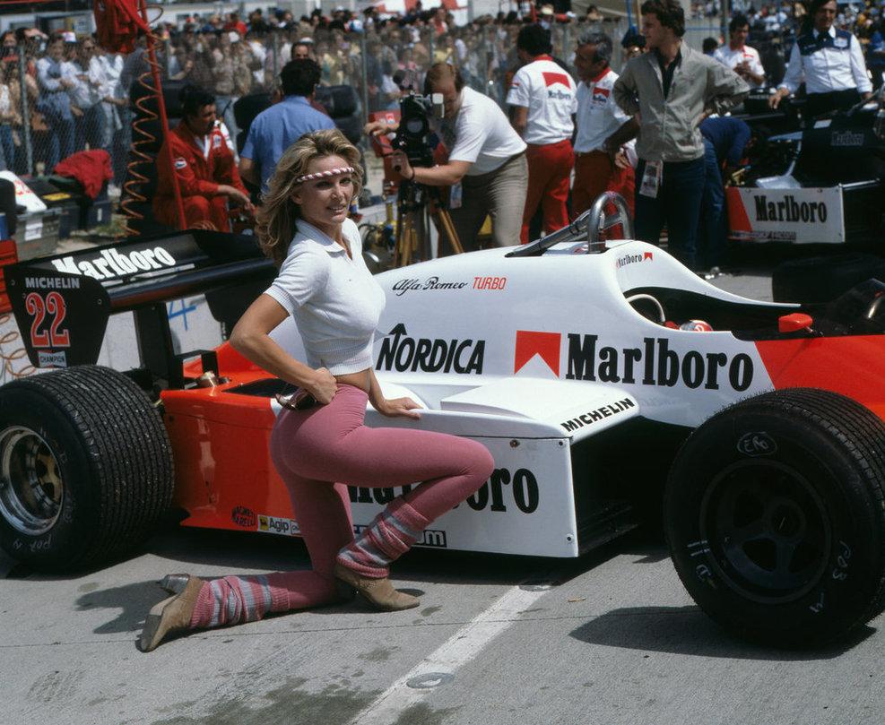 1983 Long Beach. A girl in front of Andrea de Cesaris', Alfa Romeo.