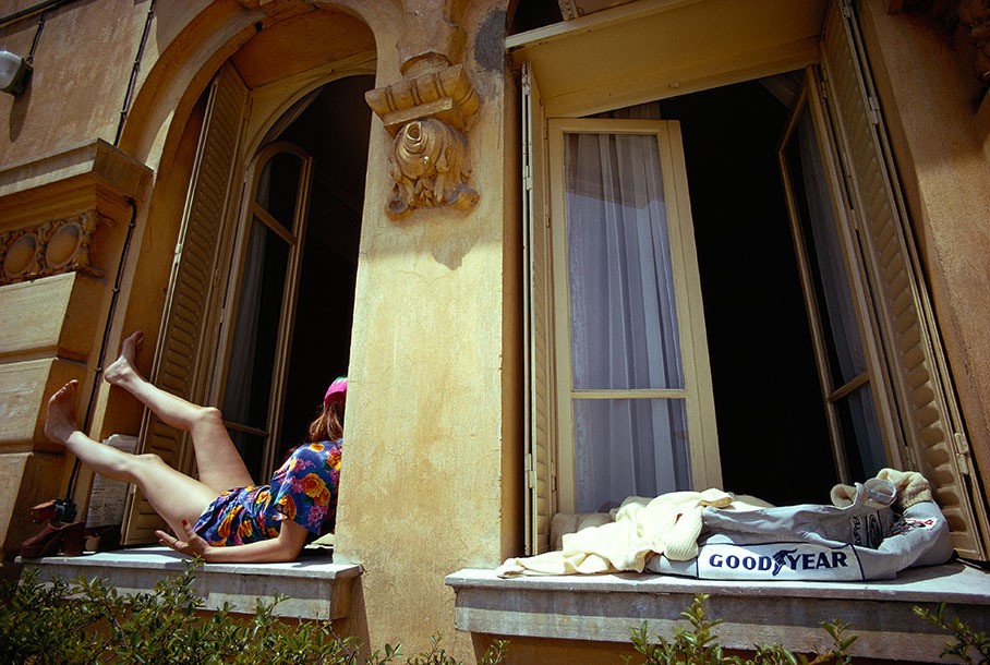 1973 Monaco Grand Prix. Christina de Caraman-Chimay relaxes in the sun while her boyfriend, Francois Cevert, takes a shower after a practice session, leaving his overalls to dry in the sun.
