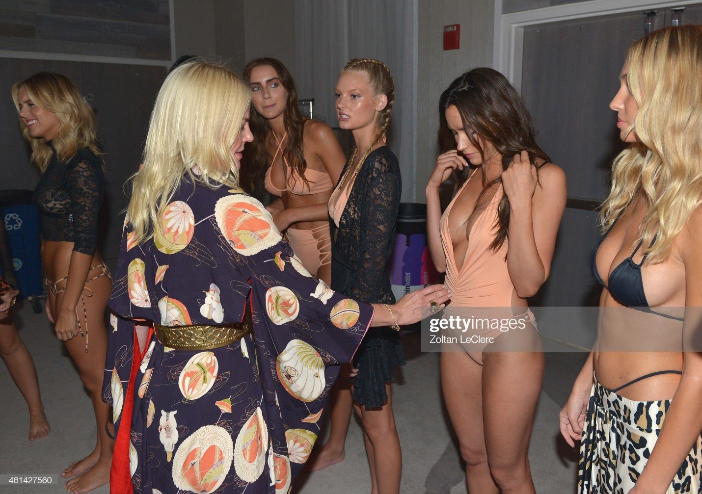 Designer Sharleen Ernster Lazear and models prepare backstage at the Hot-As-Hell fashion show during SWIMMIAMI at 1 Hotel South Beach Salon on July 19, 2015 in Miami Beach, Florida. 