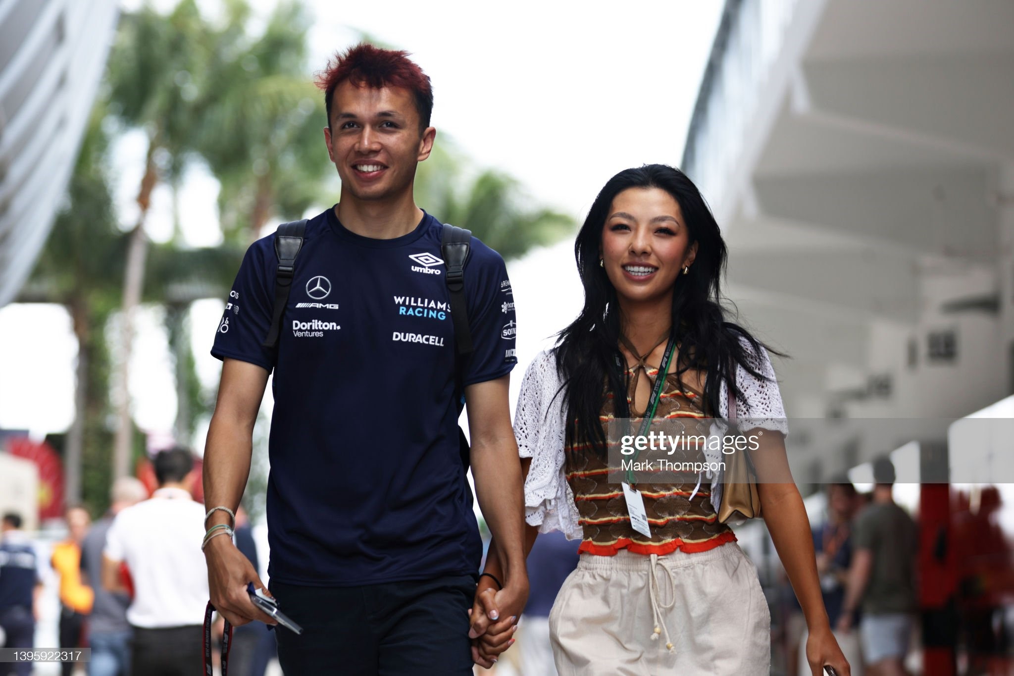 Alexander Albon of Thailand and Williams walks in the Paddock with his girlfriend, golfer Lily Muni, prior to final practice ahead of the F1 Grand Prix of Miami at the Miami International Autodrome on May 07, 2022 in Miami, Florida. 