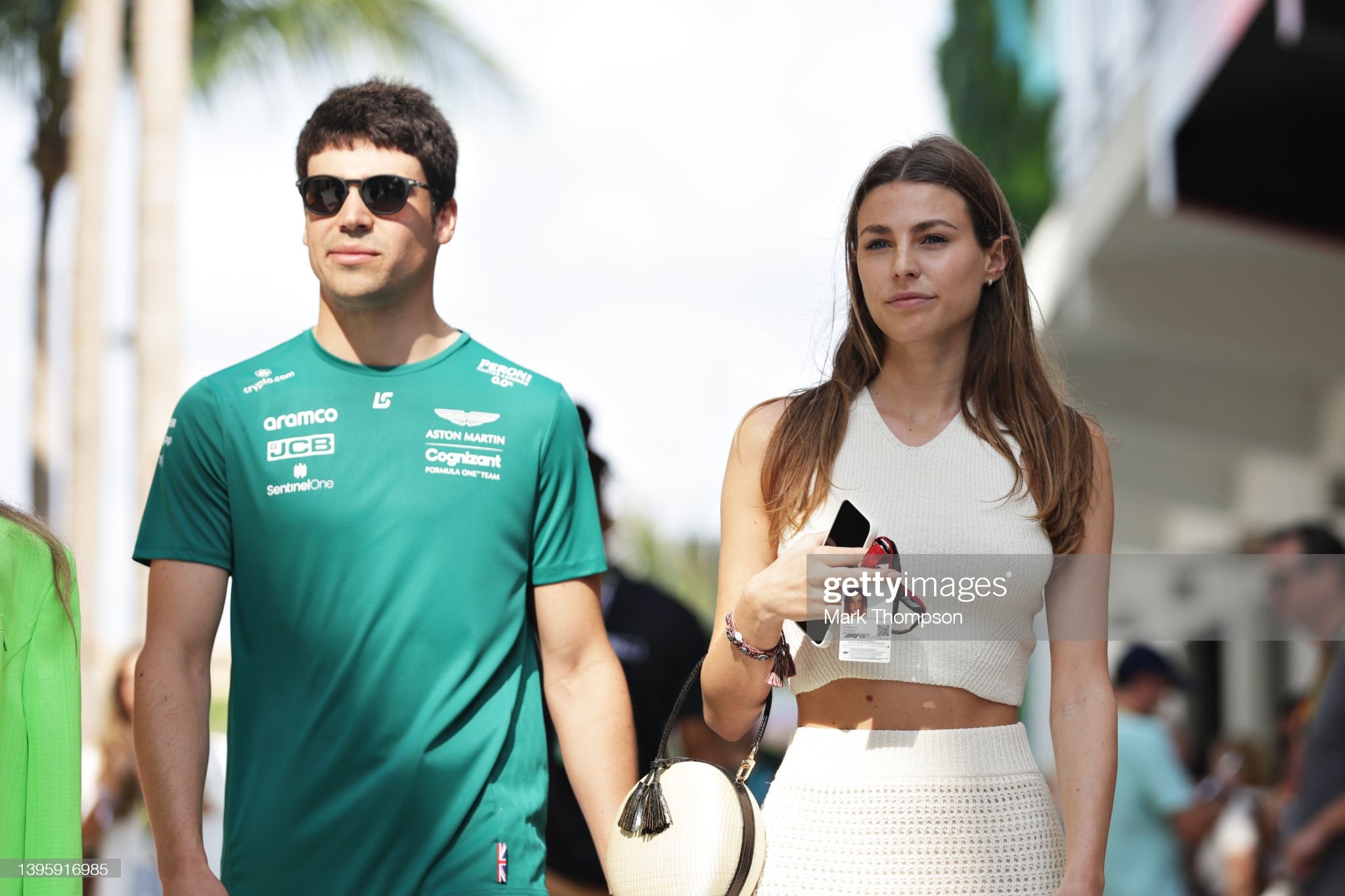 Lance Stroll of Canada and Aston Martin F1 Team walks in the Paddock with his girlfriend Sara Pagliaroli prior to final practice ahead of the F1 Grand Prix of Miami at the Miami International Autodrome on May 07, 2022 in Miami, Florida. 