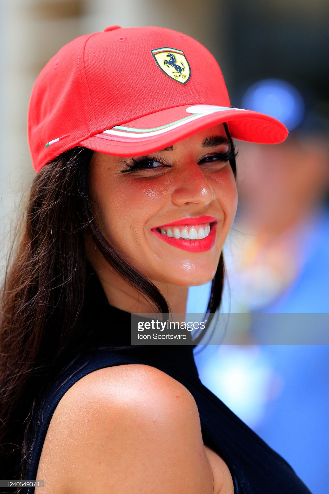 A Ferrari female fan smiles for the camera prior to the first running of the Miami Grand Prix on May 08, 2022 at the Miami International Autodrome in Miami Gardens, Florida. 