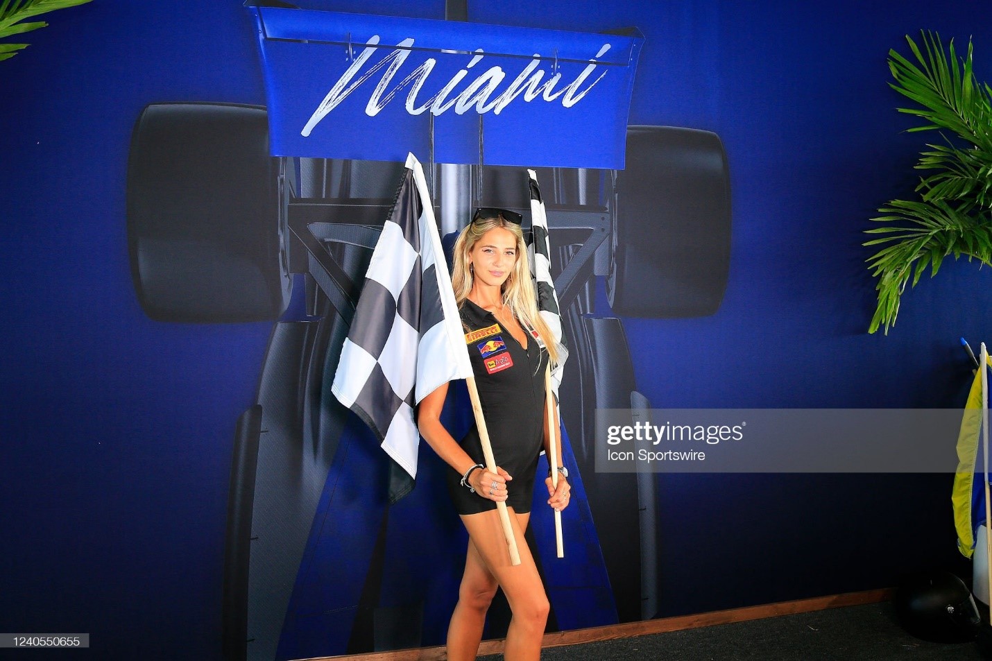 A female fan poses with a checkered flag during the first running of the Miami Grand Prix on May 08, 2022 at the Miami International Autodrome in Miami Gardens, Florida.