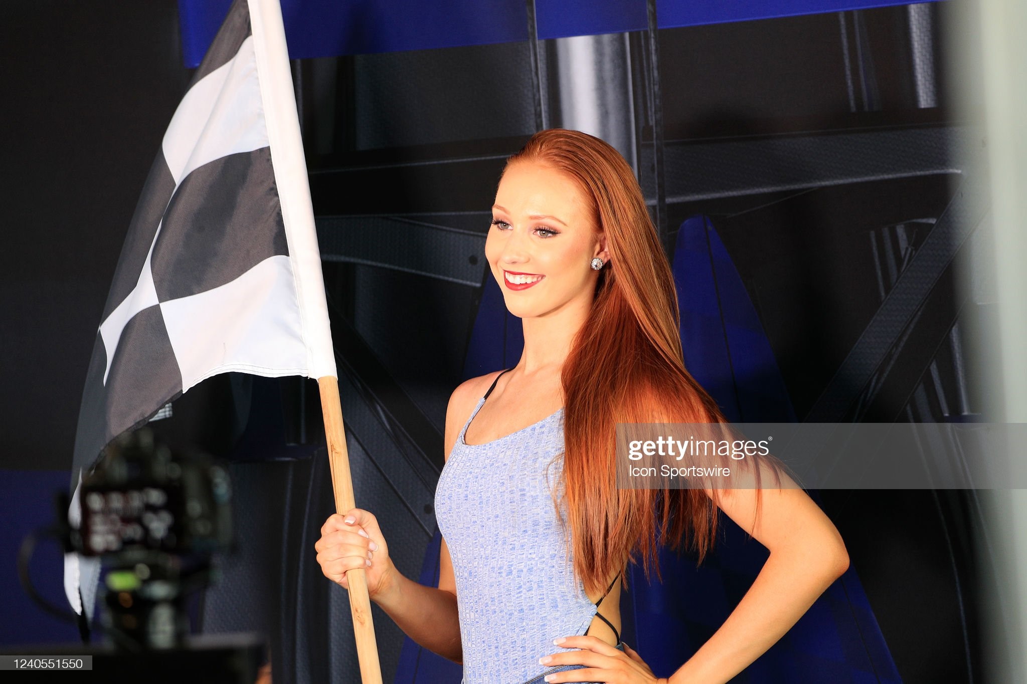 A female fan poses with a checkered flag during the first running of the Miami Grand Prix on May 08, 2022 at the Miami International Autodrome in Miami Gardens, Florida. 