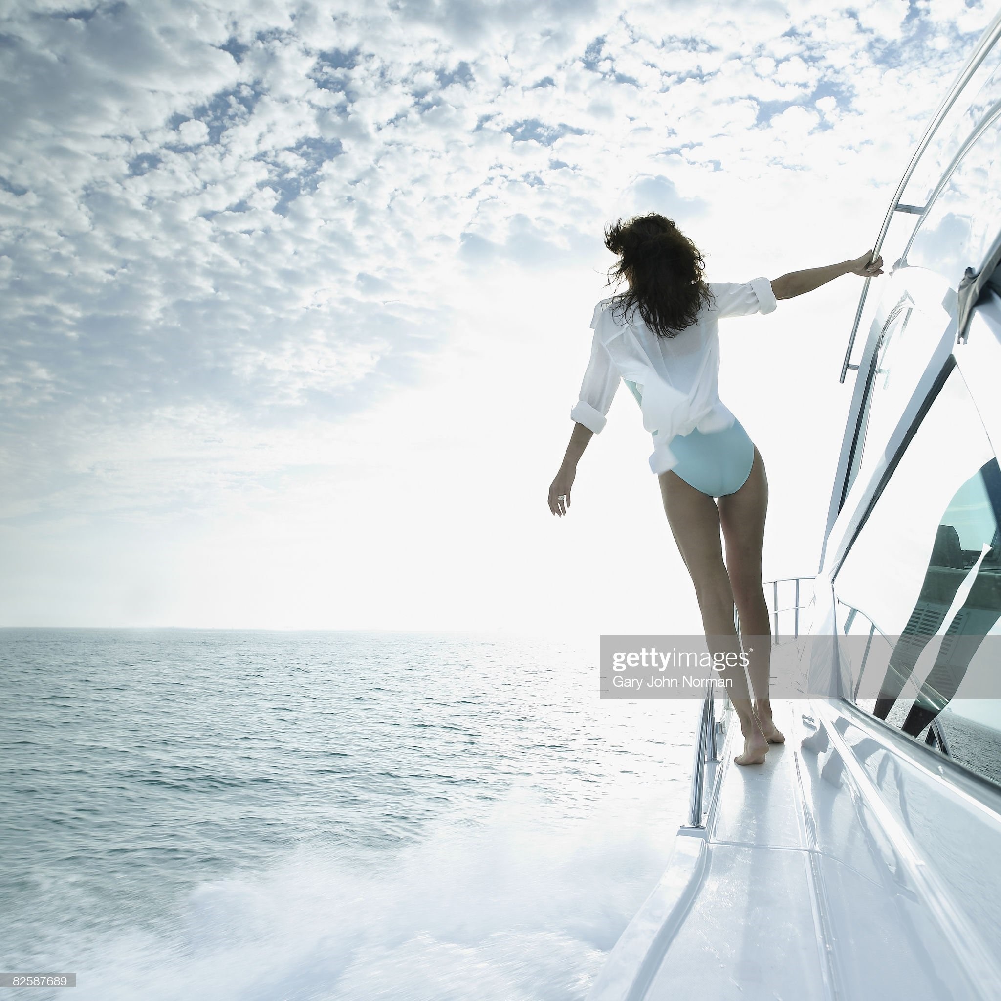 Woman enjoys the breeze on board cruiser power boat off Key Biscayne, Miami, Florida. 