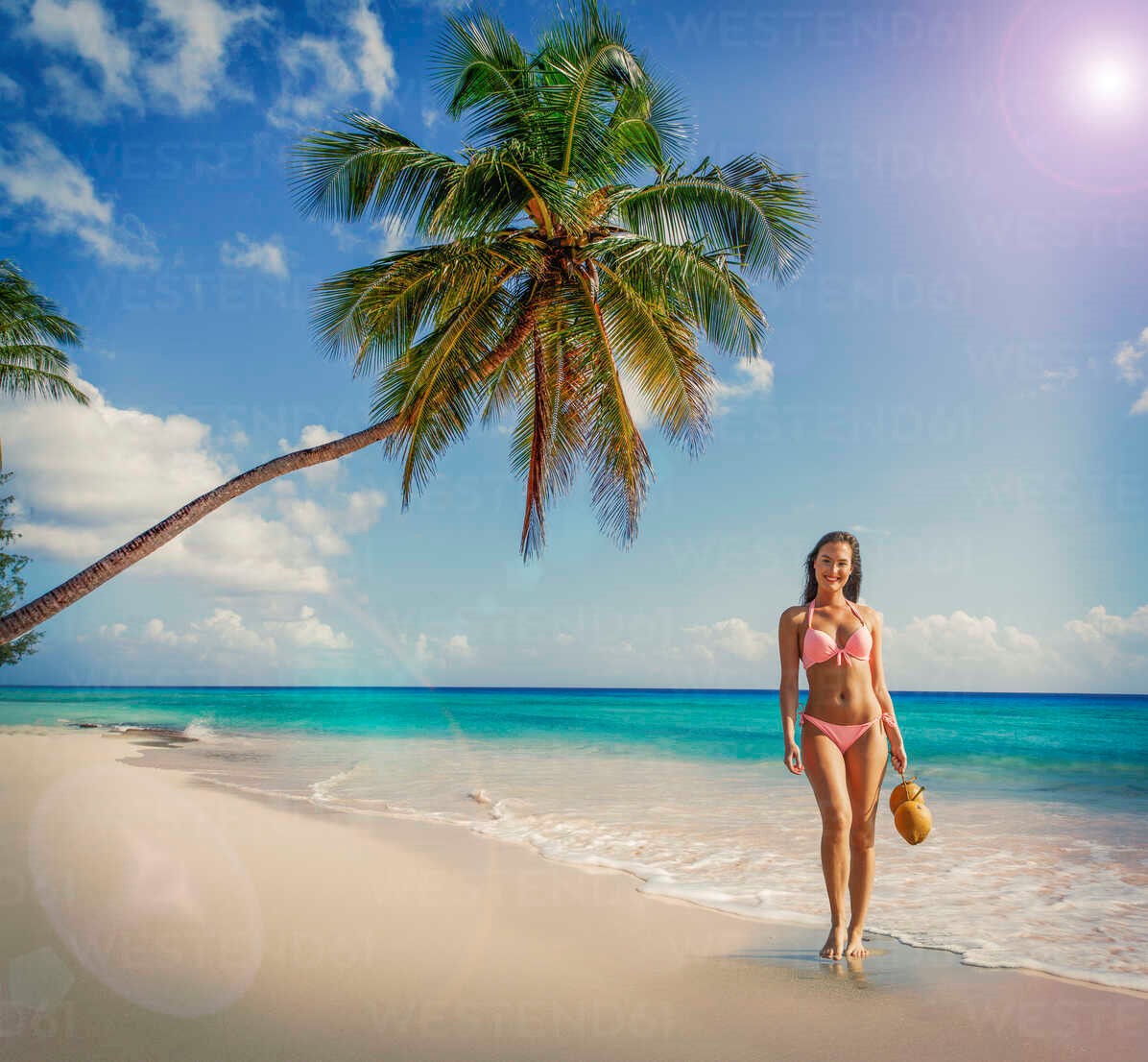 Portrait of young woman wearing bikini standing on Miami beach, Florida.