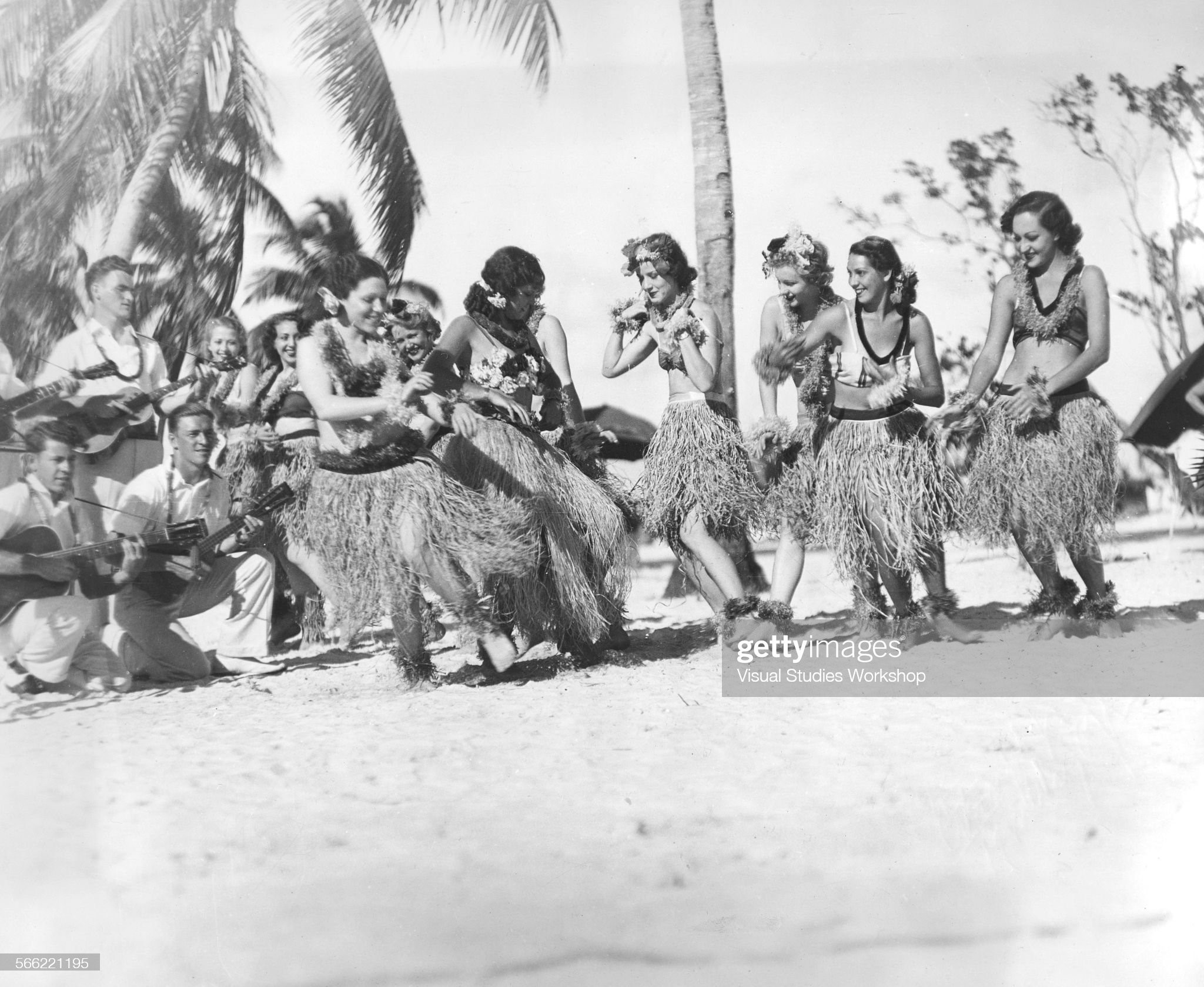 Two native Hawaiian hula instructors, Princesses Hilo Kuku and Mauna Loa, tutor girls on how to hula, Miami, Florida, early to mid 20th century. January 01, 1930.