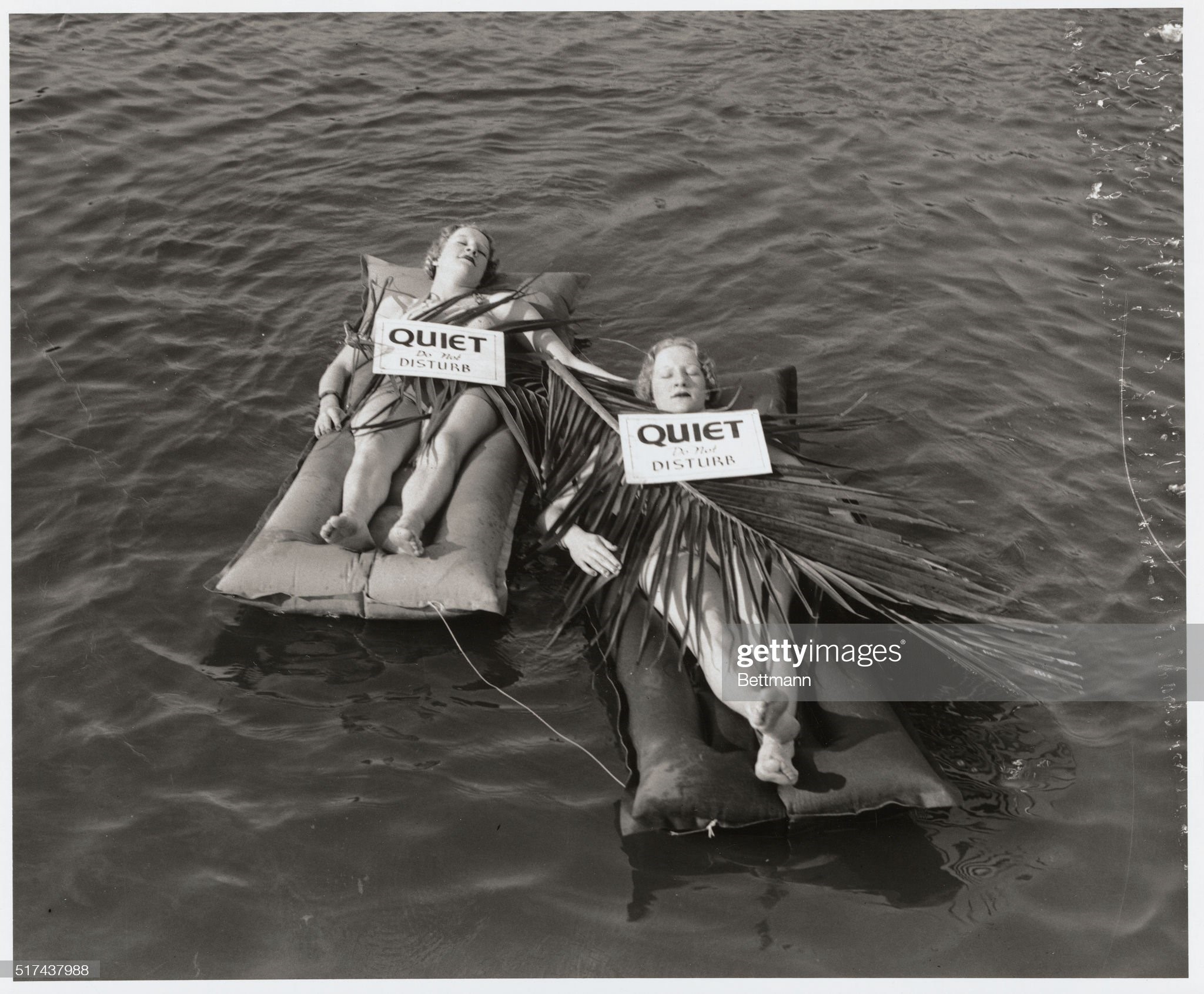 Sea cradles for slumbering sirens. In the cradle of the deep, Lorraine and Loretta Stanley, Miami bathing beauties, are slumbering peacefully on their inflated beds. The 
