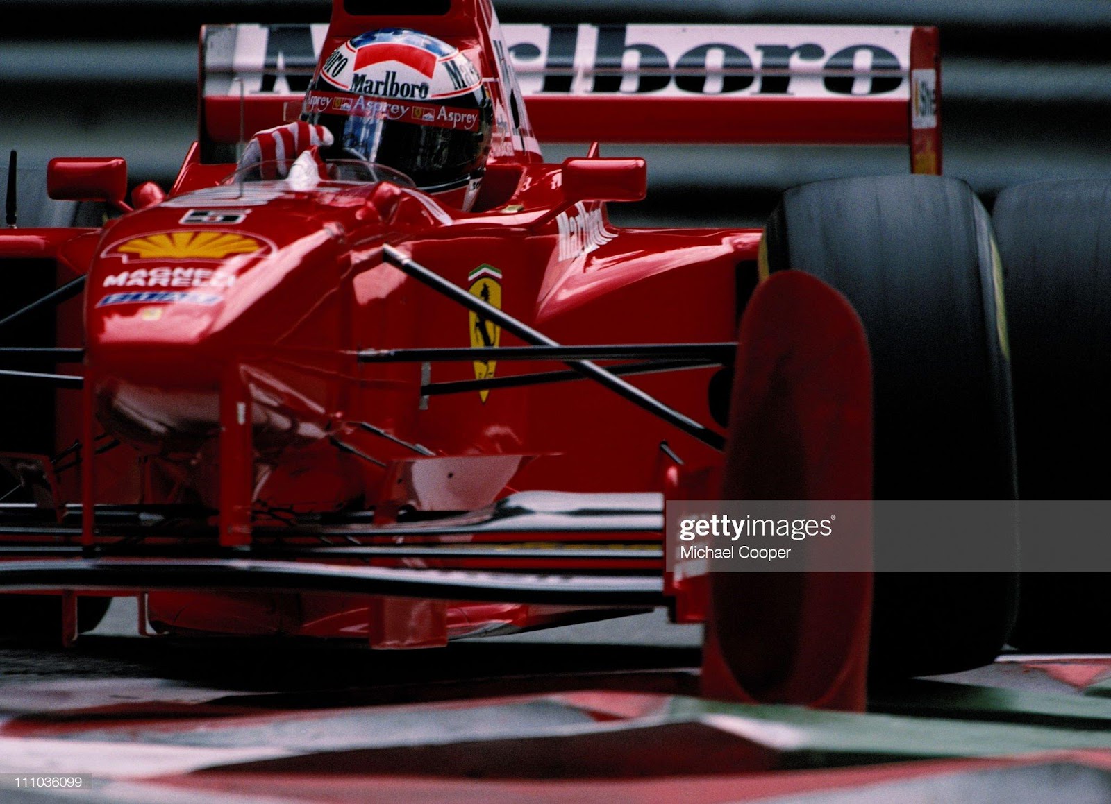 Michael Schumacher drives the n. 5 Ferrari F310B over the curbs during practice for the Belgian Grand Prix on 23rd August 1997 at the Circuit de Spa-Francorchamps. 