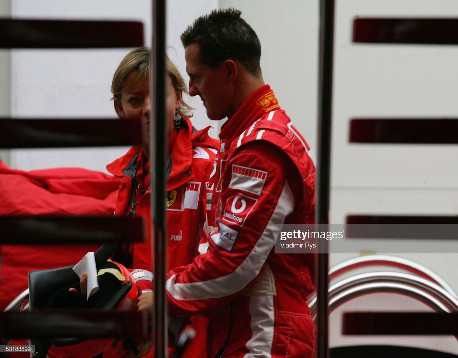 Michael Schumacher, Ferrari, talks with his press officer Sabine Kehm after the qualifying for the French F1 Grand Prix at Magny Cours on July 2, 2005.