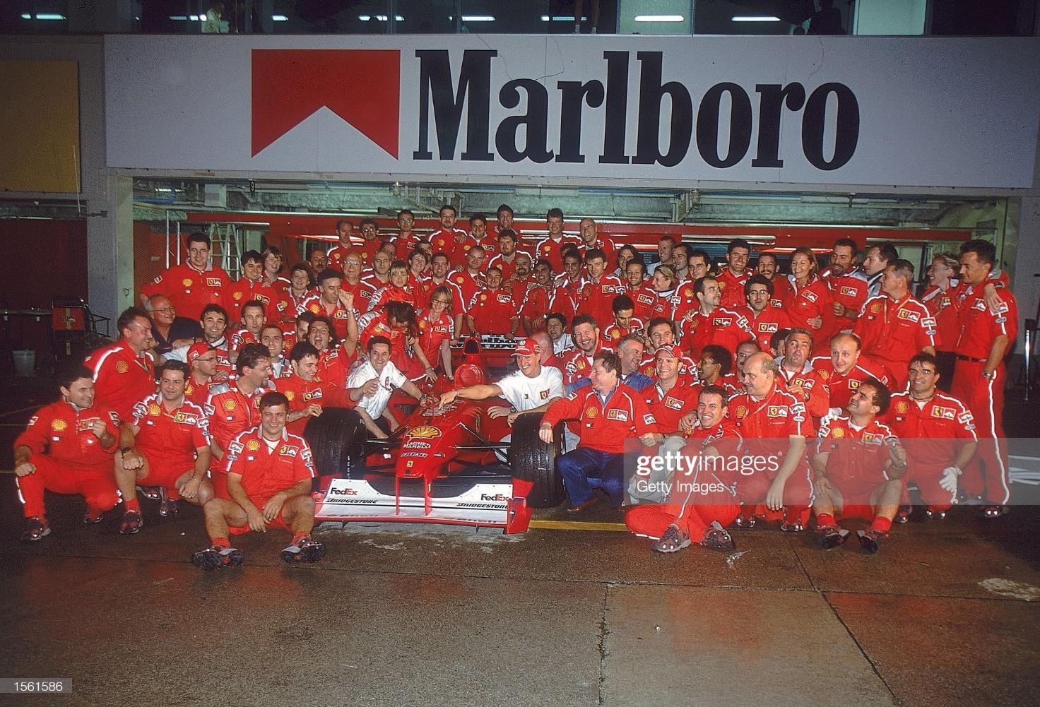 8 October 2000: Michael Schumacher and Rubens Barrichello celebrate with the rest of the Ferrari team after the Japanese F1 Grand Prix in Suzuka.
