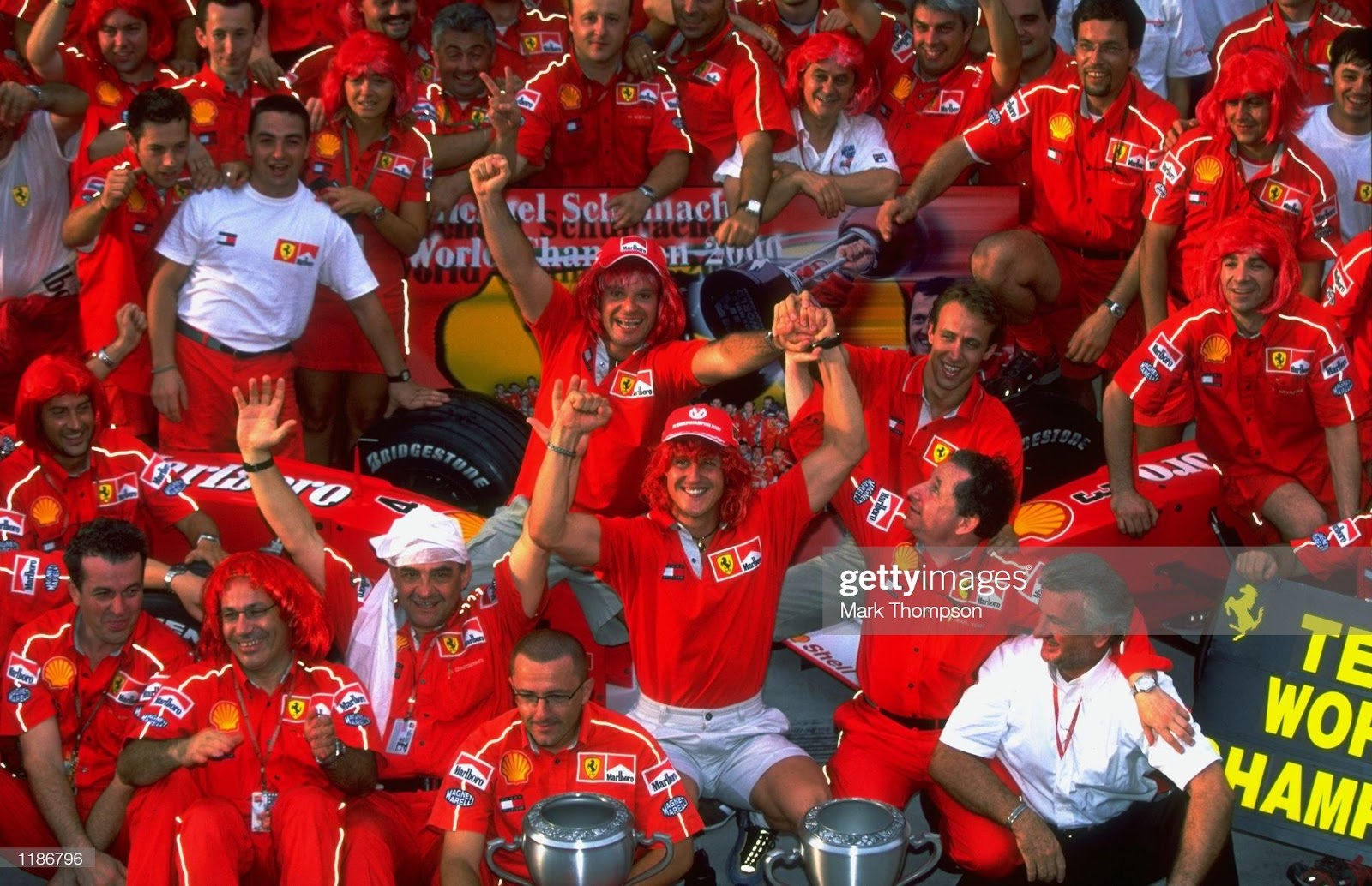 22 October 2000: Michael Schumacher, Ferrari, celebrates winning with the Ferrari team their two titles after the Malaysian F1 Grand Prix at the Sepang Circuit, in Kuala Lumpur.