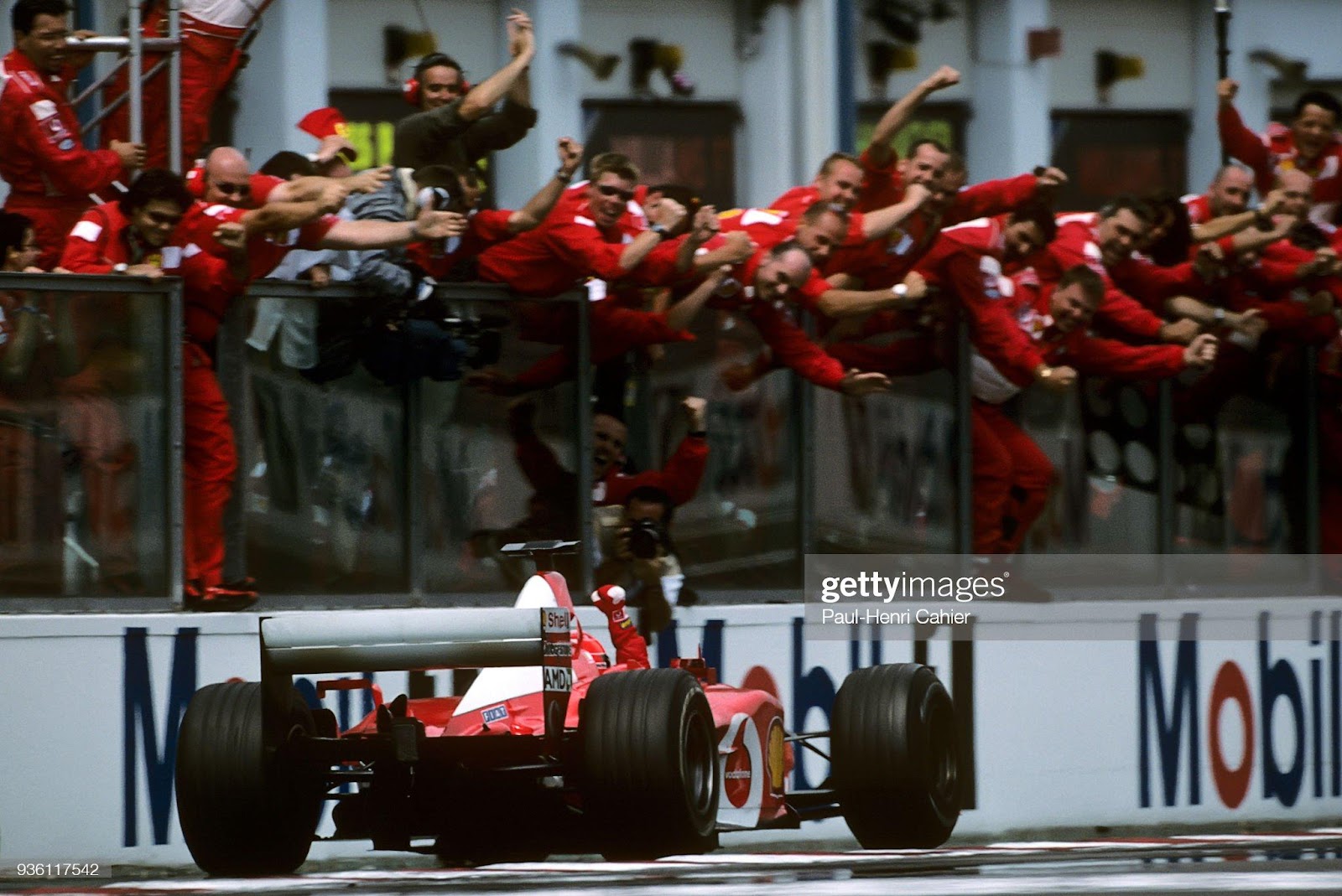 Michael Schumacher, Ferrari F2002, claims victory in the Grand Prix of France, Circuit de Nevers Magny-Cours, 21 July 2002. 