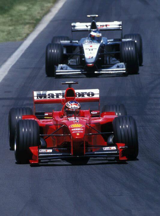 Michael Schumacher, Ferrari, ahead of Mika Hakkinen, McLaren.