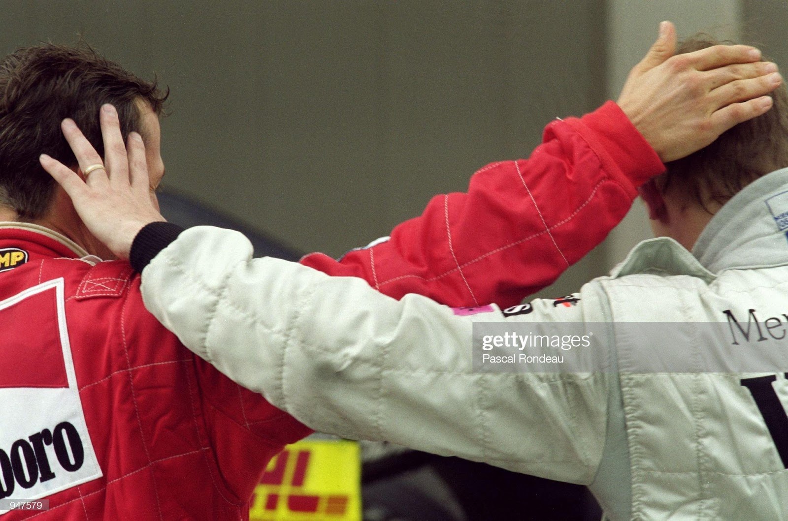 29 Apr 2001: Ferrari driver Michael Schumacher consoles McLaren Mercedes driver Mika Hakkinen after Mika breaks down on the final lap whilst leading the F1 Spanish Grand Prix at the Circuit de Catalunya in Barcelona, Spain. Schumacher won the race.