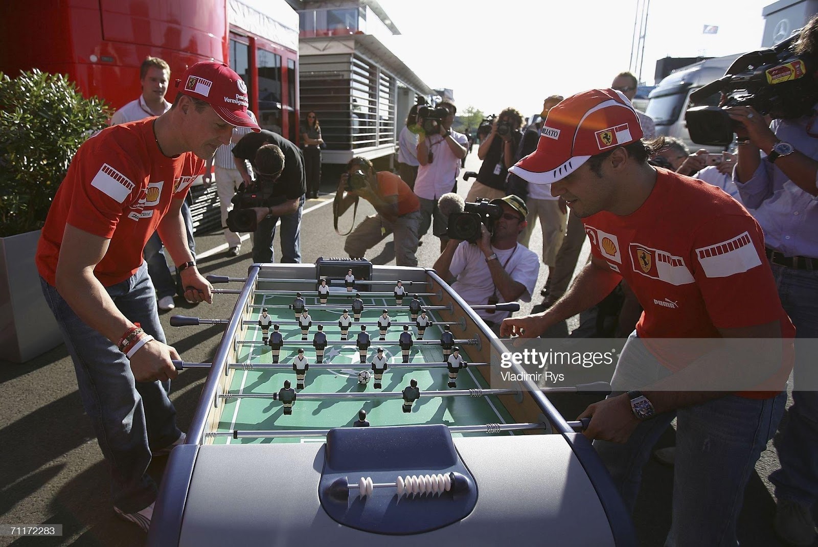 Michael Schumacher (left) and his Ferrari team mate Felipe Massa play a table football in the paddock after the qualifying for the F1 British Grand Prix at Silverstone on June 10, 2006.