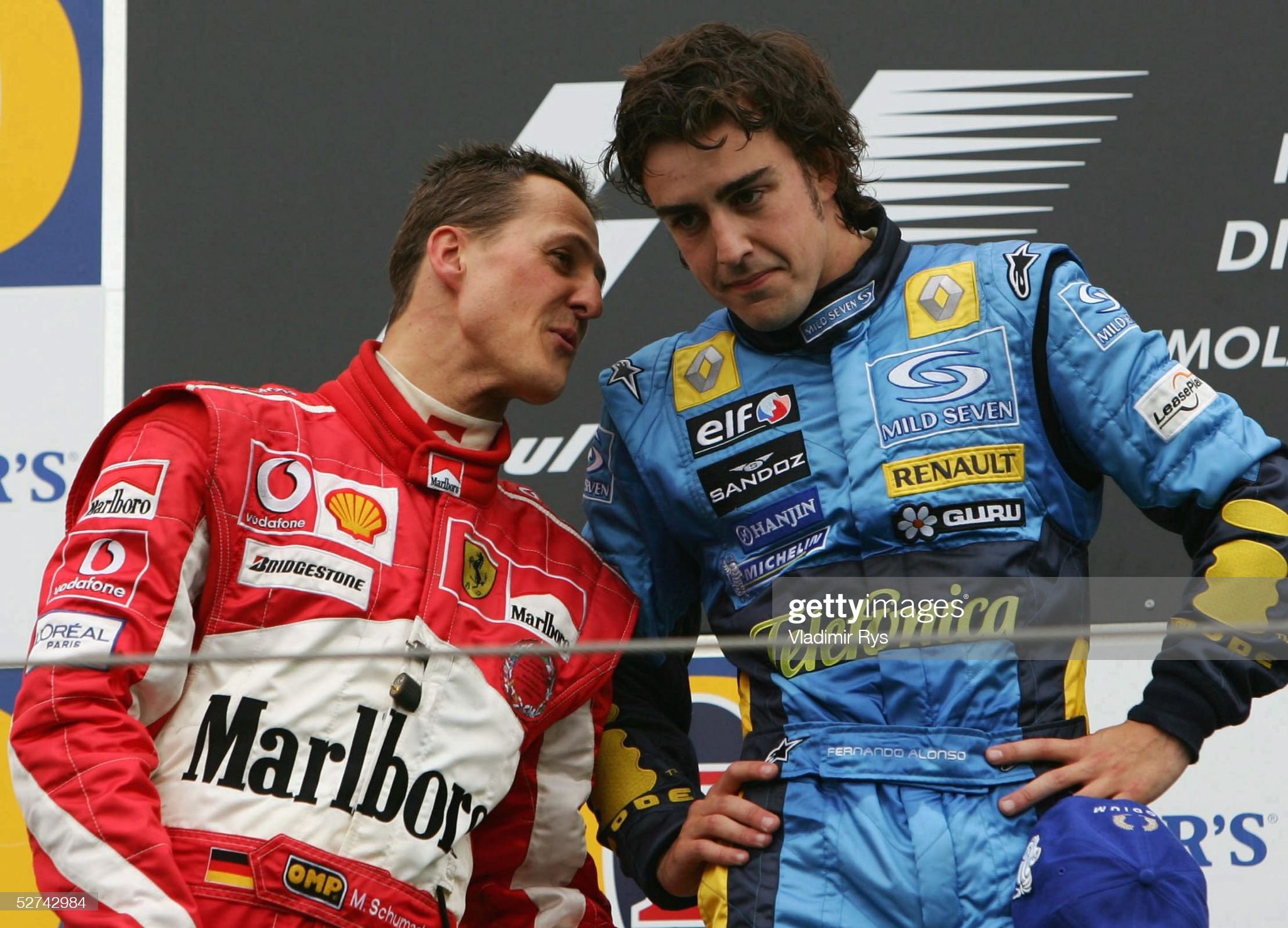 Fernando Alonso of Spain and Renault and Michael Schumacher of Ferrari and Germany speak on the podium after Alonso's victory in the San Marino F1 Grand Prix on April 24, 2005 in Imola, Italy.