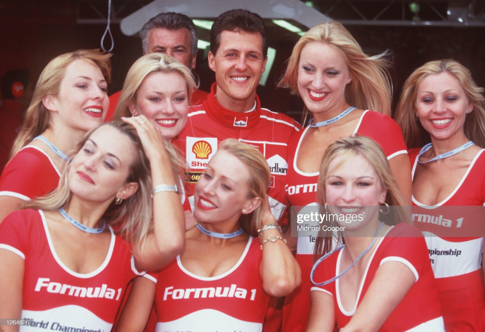 7 March 1998: Ferrari driver Michael Schumacher enjoying the perks of his job with the Formula One girls before the Australian Grand Prix at Albert Park in Melbourne.