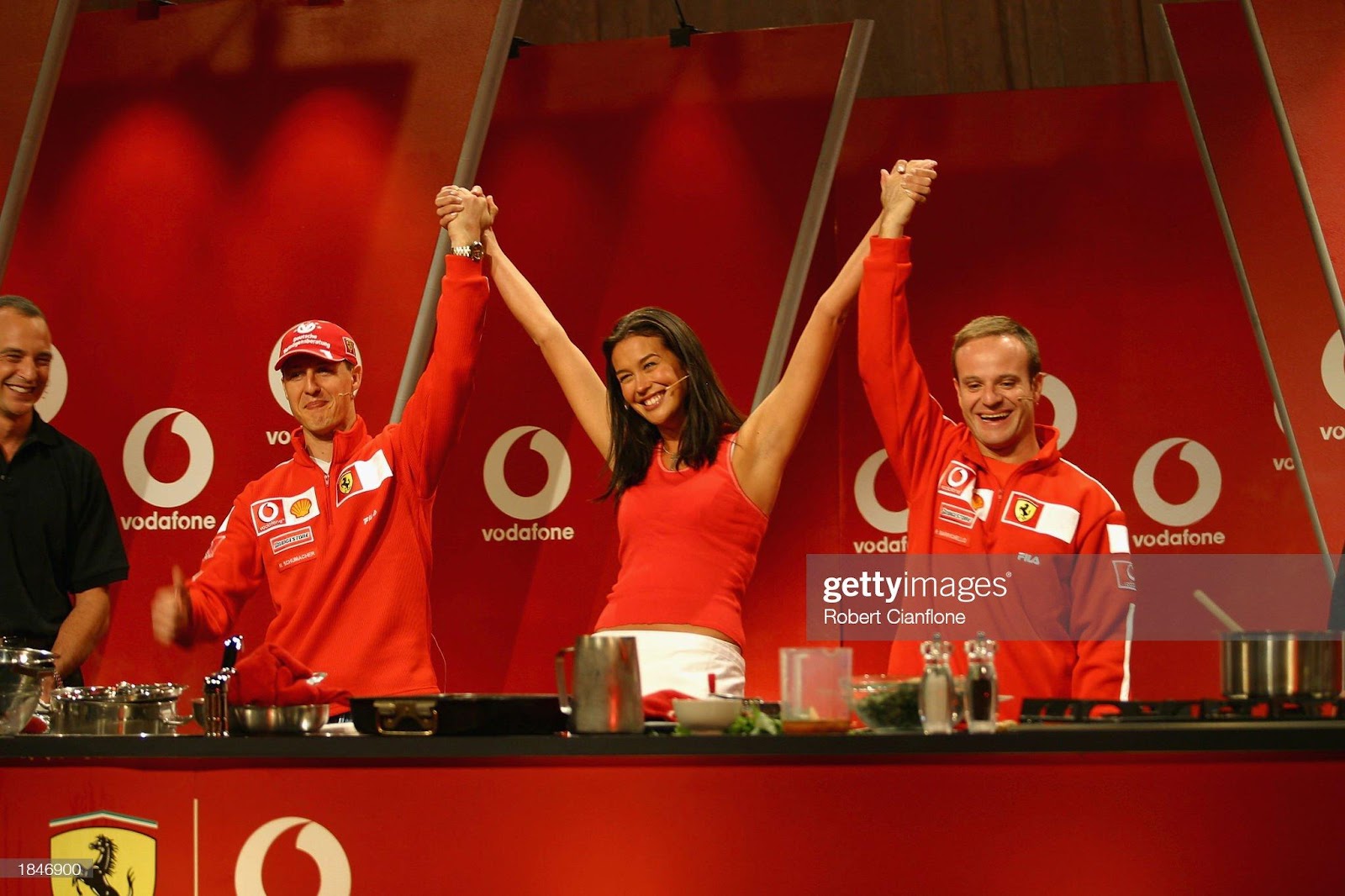 Michael Schumacher and Rubens Barrichello join supermodel Megan Gale in the Ferrari Cook Off held at the Vodafone Arena as part of the Australian F1 Grand Prix at Albert Park in Melbourne, on March 6, 2002. 
