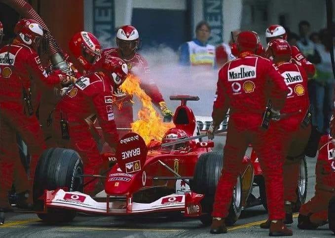 Michael Schumacher in his Ferrari on fire.