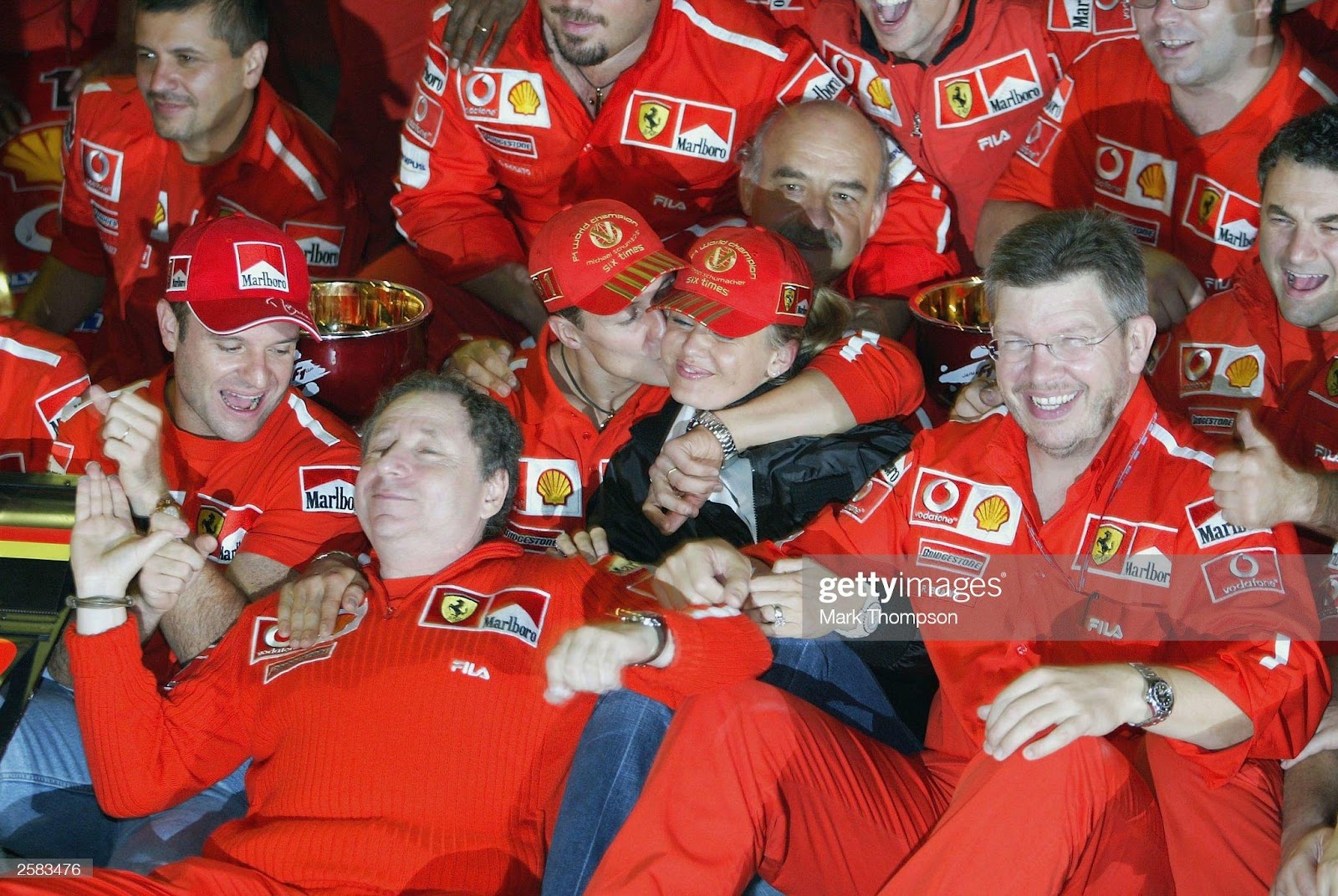 Michael Schumacher, Ferrari, poses with his wife Corinna for a celebratory team photo during the F1 Japanese Grand Prix in Suzuka on October 12, 2003.