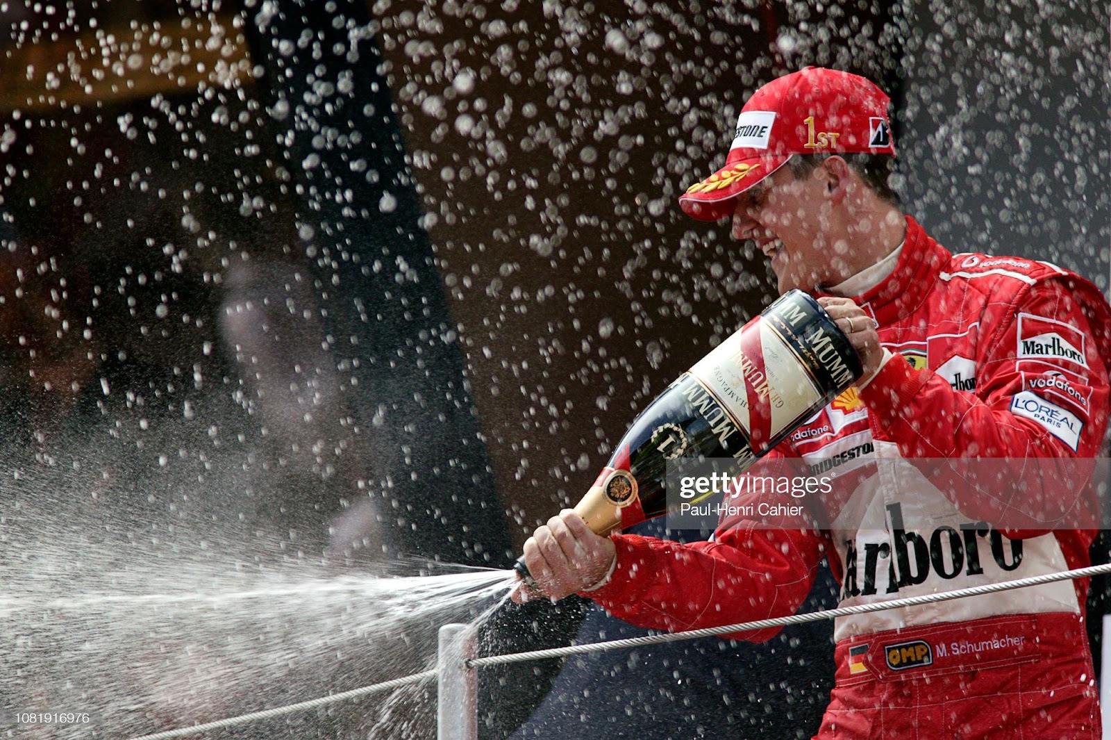 Michael Schumacher on the podium with champagne.
