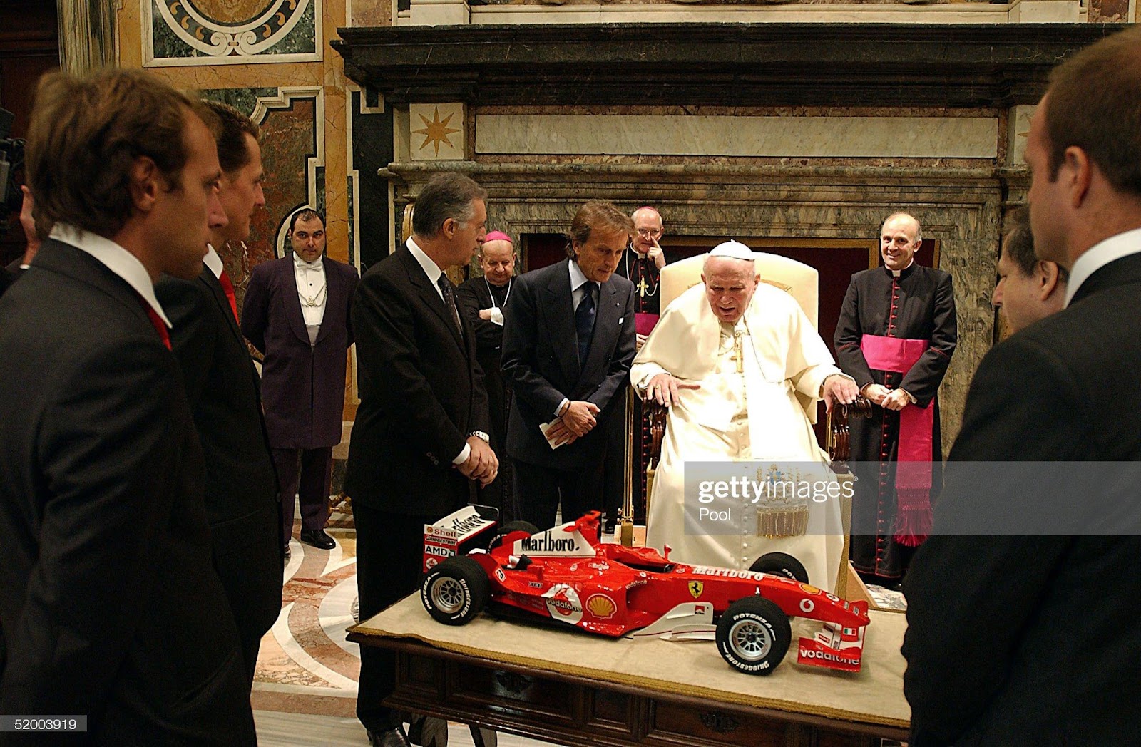 Pope John Paul II receives as a gift from Ferrari President Luca Cordero di Montezemolo, Michael Schumacher, Brazilian teammate Rubens Barrichello, Ferrari managing director, F1 team boss Jean Todt and mechanics a 1:5 scale model of the car that won Ferrari both the championship and constructor title in 2004 during a meeting at the Clementina Hall, January 17, 2005, in Vatican City.