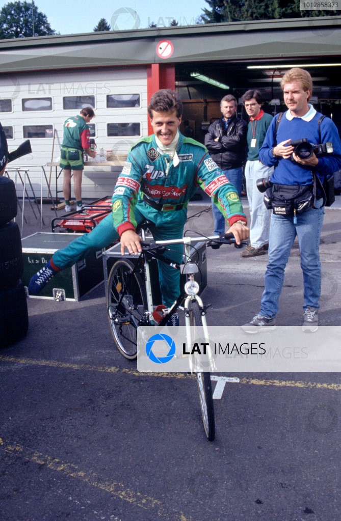 Michael Schumacher at Benetton riding a bicicle.