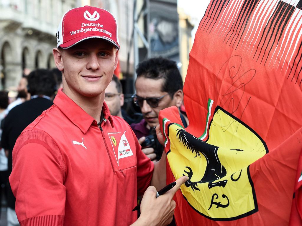 Mick Schumacher and a Ferrari flag.