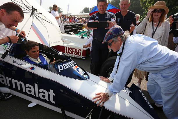 Chichester, England. Former F1 World Champions Nelson Piquet (left) sits in the cockpit of the Brabham BT52 from 1983 as Sir Jackie Stewart looks on at Goodwood Festival of Speed on July 14, 2013.