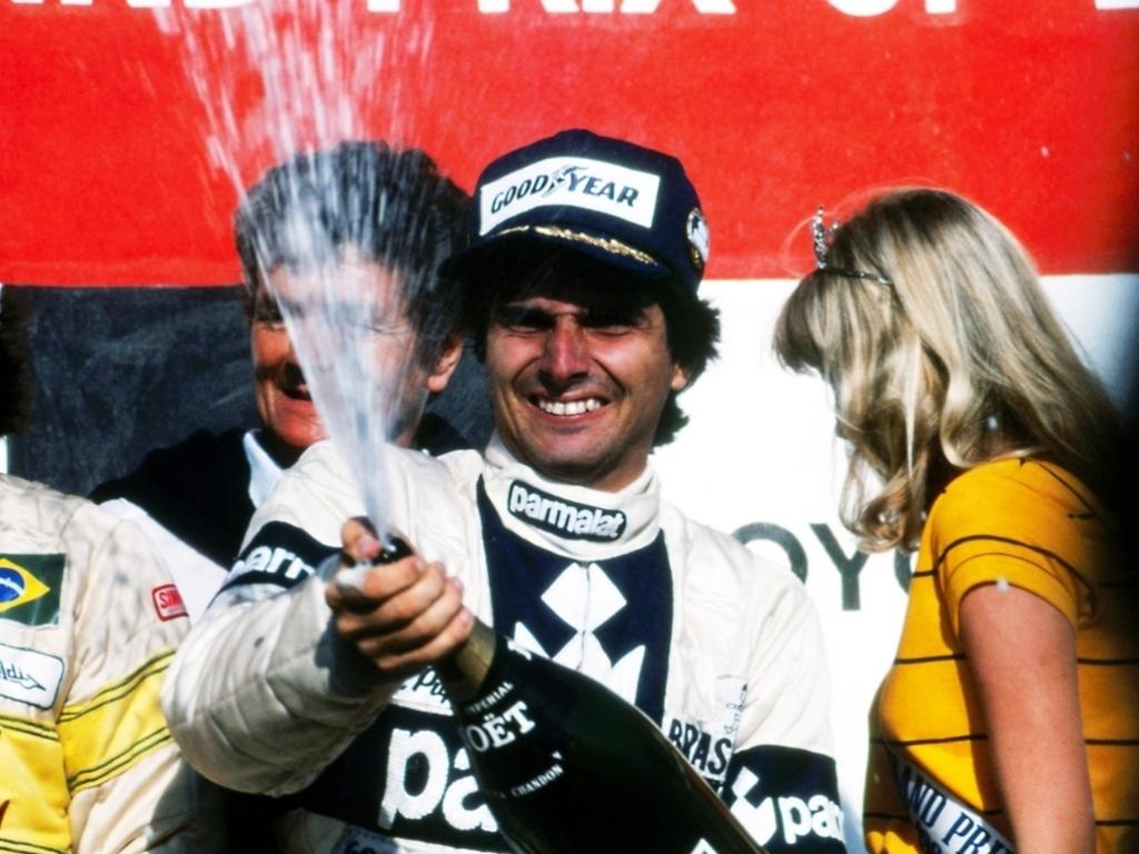 Nelson Piquet on the podium with a blonde girl.