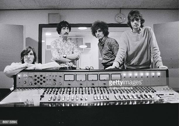 Photo of Pink Floyd; From left: Roger Waters, Nick Mason, Syd Barrett and Rick Wright, standing behind mixing desk in recording studio control room.