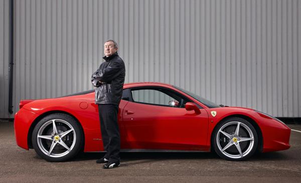 Nick Mason in front of a red Ferrari.