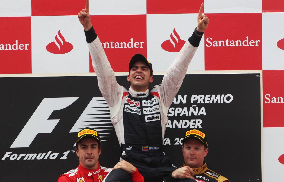 Fernando Alonso, Pastor Maldonado and Kimi Raikkonen on the podium.