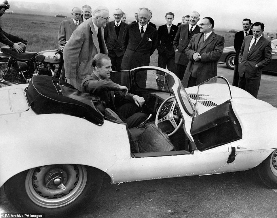 April 1957: The Duke of Edinburgh is seen trying the passenger's seat of the new 3.5 litre Jaguar XKSS sports car during his visit to the Motor Industry Research Association's headquarters near Nuneaton, Warwickshire.