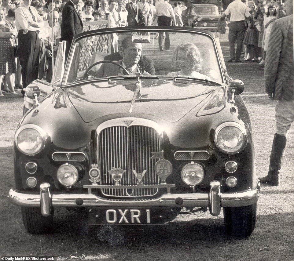 August 1964: the Duke Of Edinburgh drives his daughter Princess Anne through Windsor Great Park.