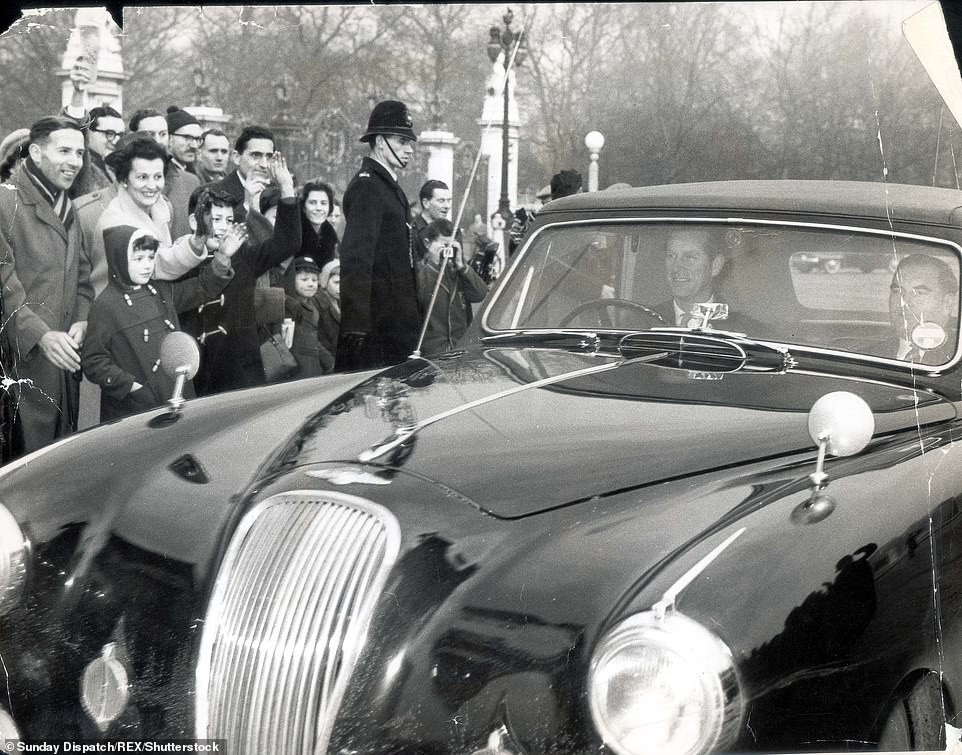 February 1960: Prince Philip at the wheel of his car as he arrived back at Buckingham Palace, from Sandringham to be with the Queen as she expected her third child, Prince Andrew.