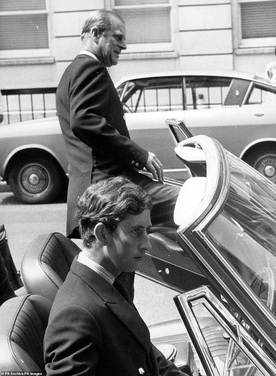 The Duke of Edinburgh about to get into an Aston Martin car, driven by the Prince of Wales, outside King Edward VII Hospital for Officers in Beaumont Street, London. The Royal father and son had visited Princess Anne, a patent at the hospital.