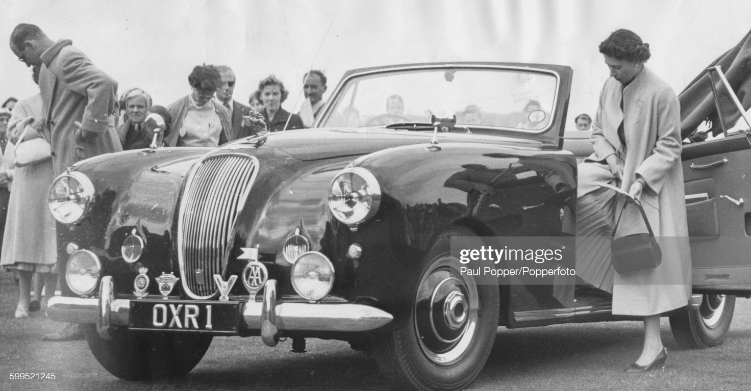 Queen Elizabeth II and Prince Philip (left of car) getting in to their 3 litre Aston Martin Lagonda DHC convertible car after a polo match at Cowdray Park in West Sussex, England on June 3rd 1956. 